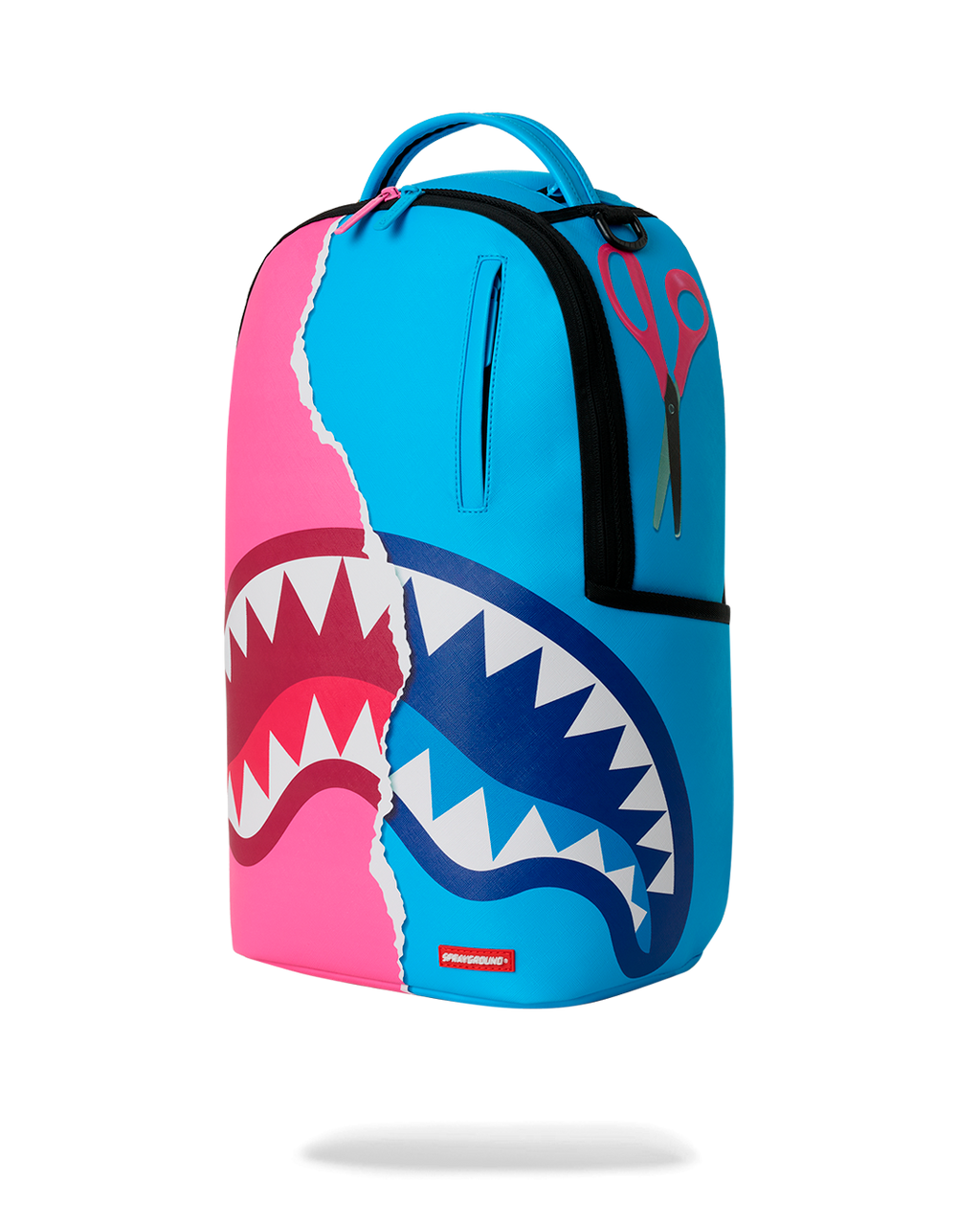 Three-quarter view of teal-and-pink shark graphic mini backpack with top handle