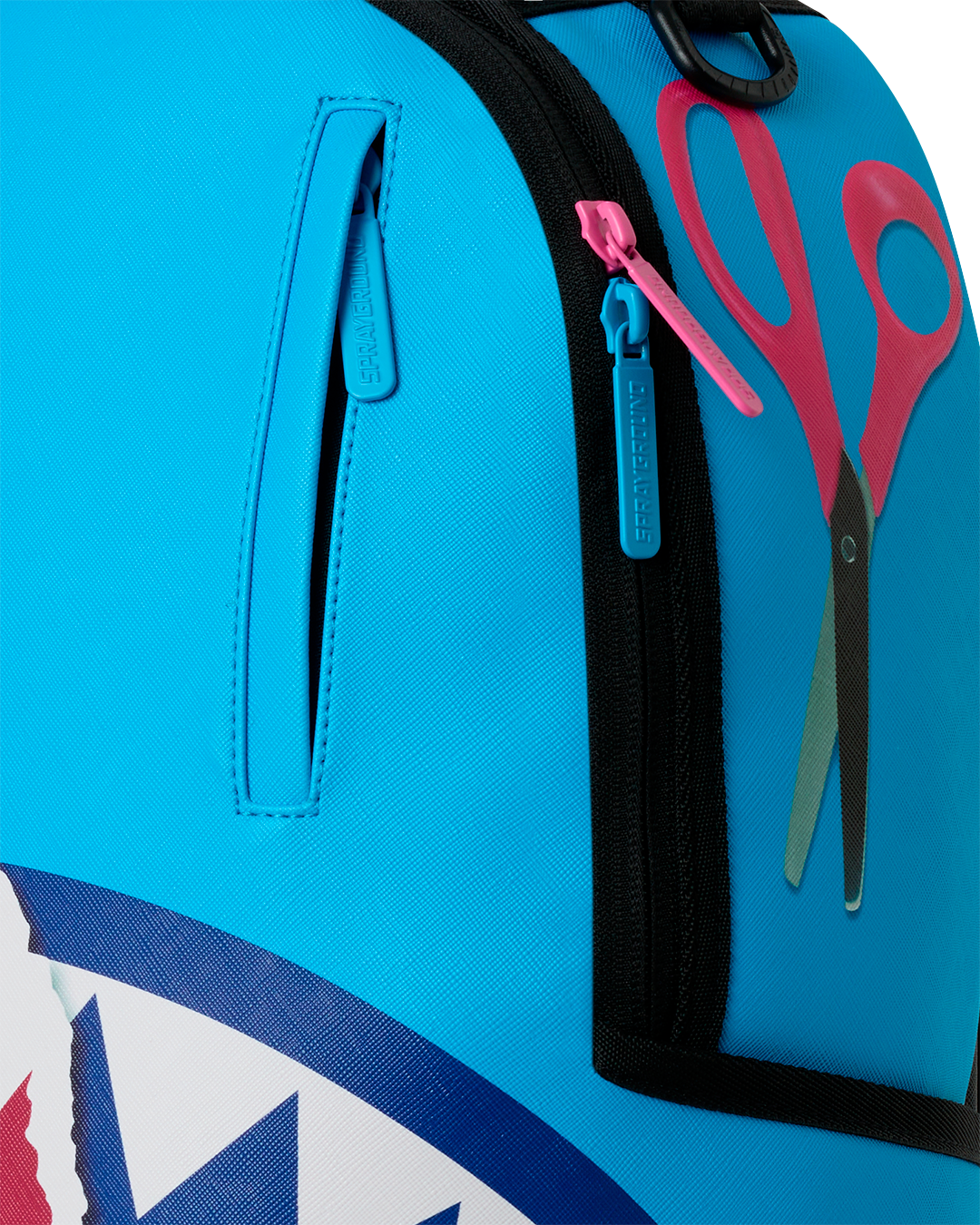 Close-up of teal front pocket and zipper on shark-themed mini backpack