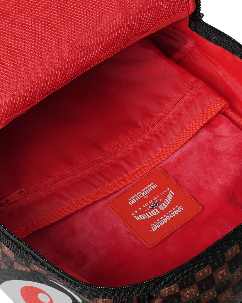 Backpack bag interior with red lining and zippered pocket panel