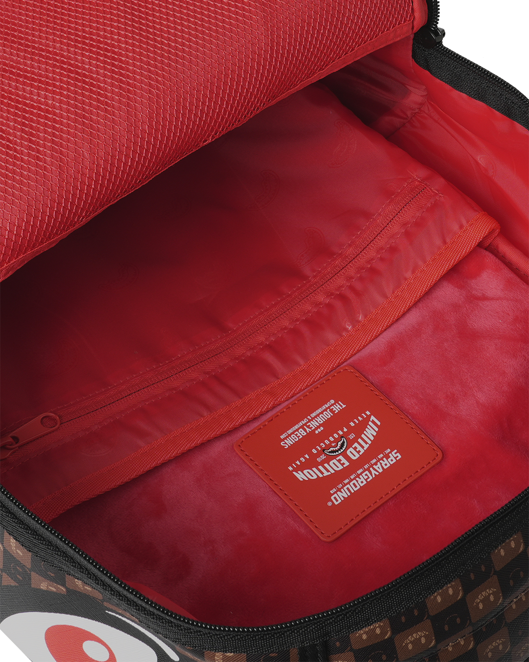 Backpack bag interior with red lining and zippered pocket panel