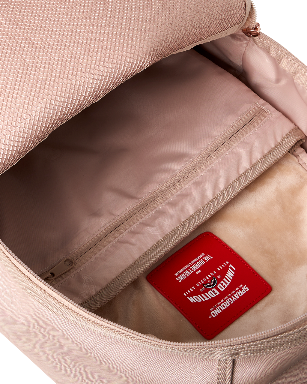 Rose-pink backpack bag interior with zip pocket and red brand label