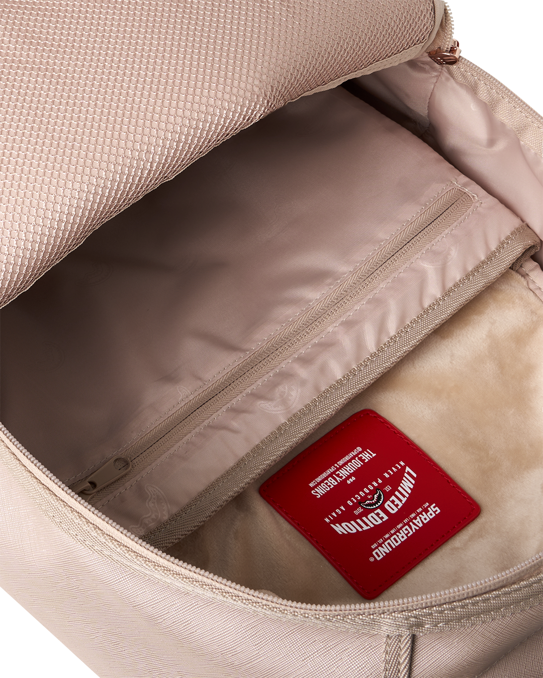 Rose-pink backpack bag interior with zip pocket and red brand label