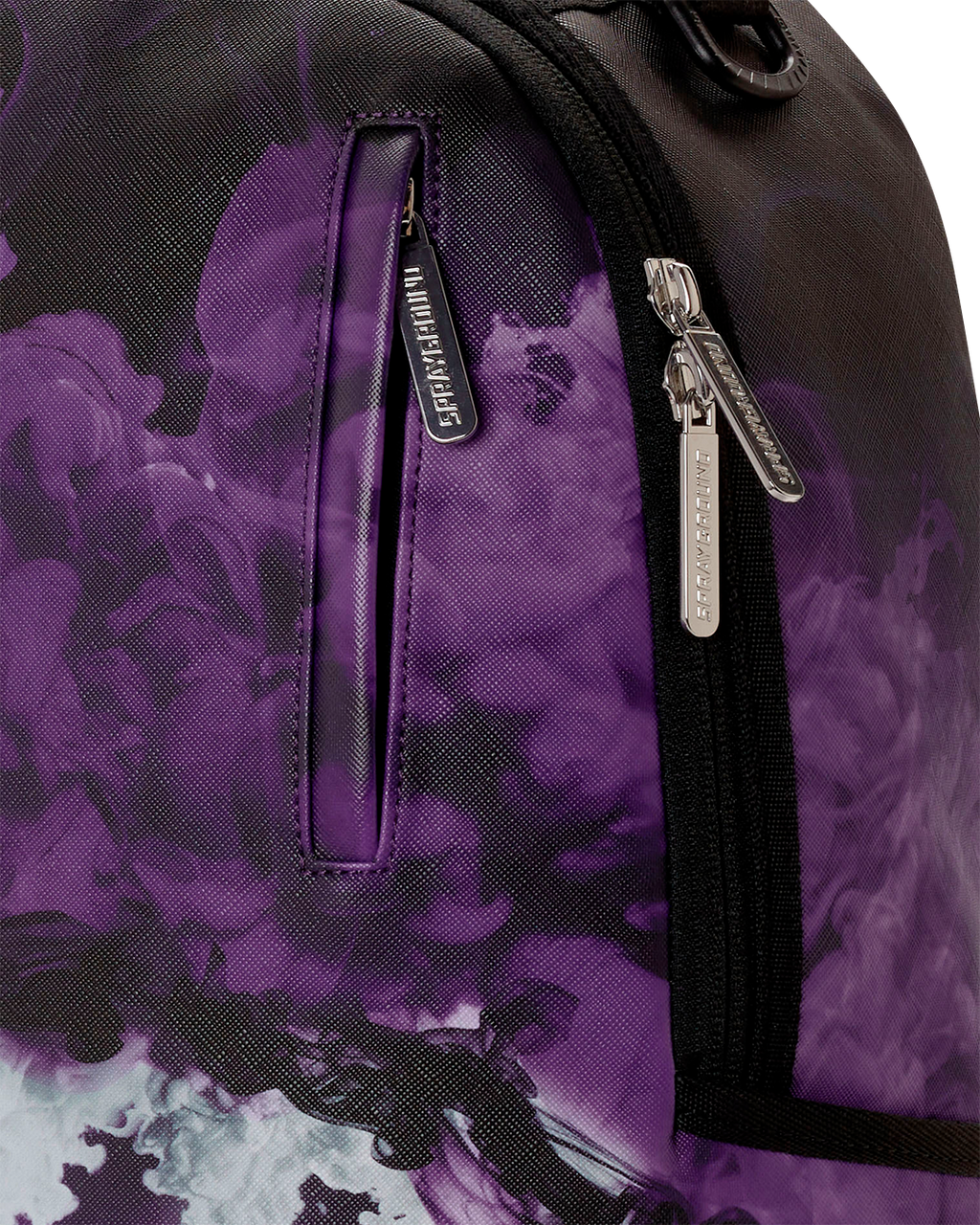 Purple backpack bag close-up of black zipper pull and graphic fabric panels