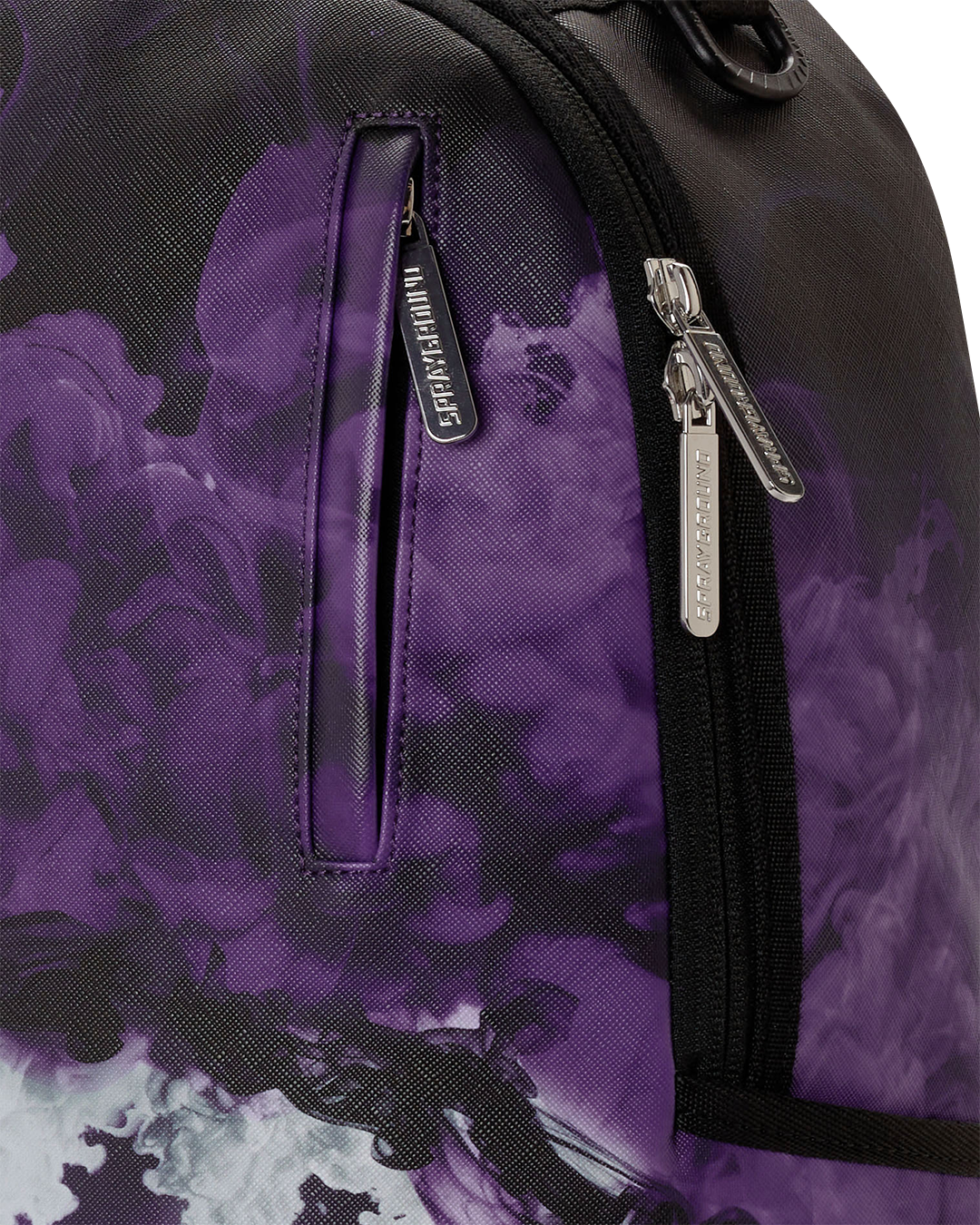 Purple backpack bag close-up of black zipper pull and graphic fabric panels