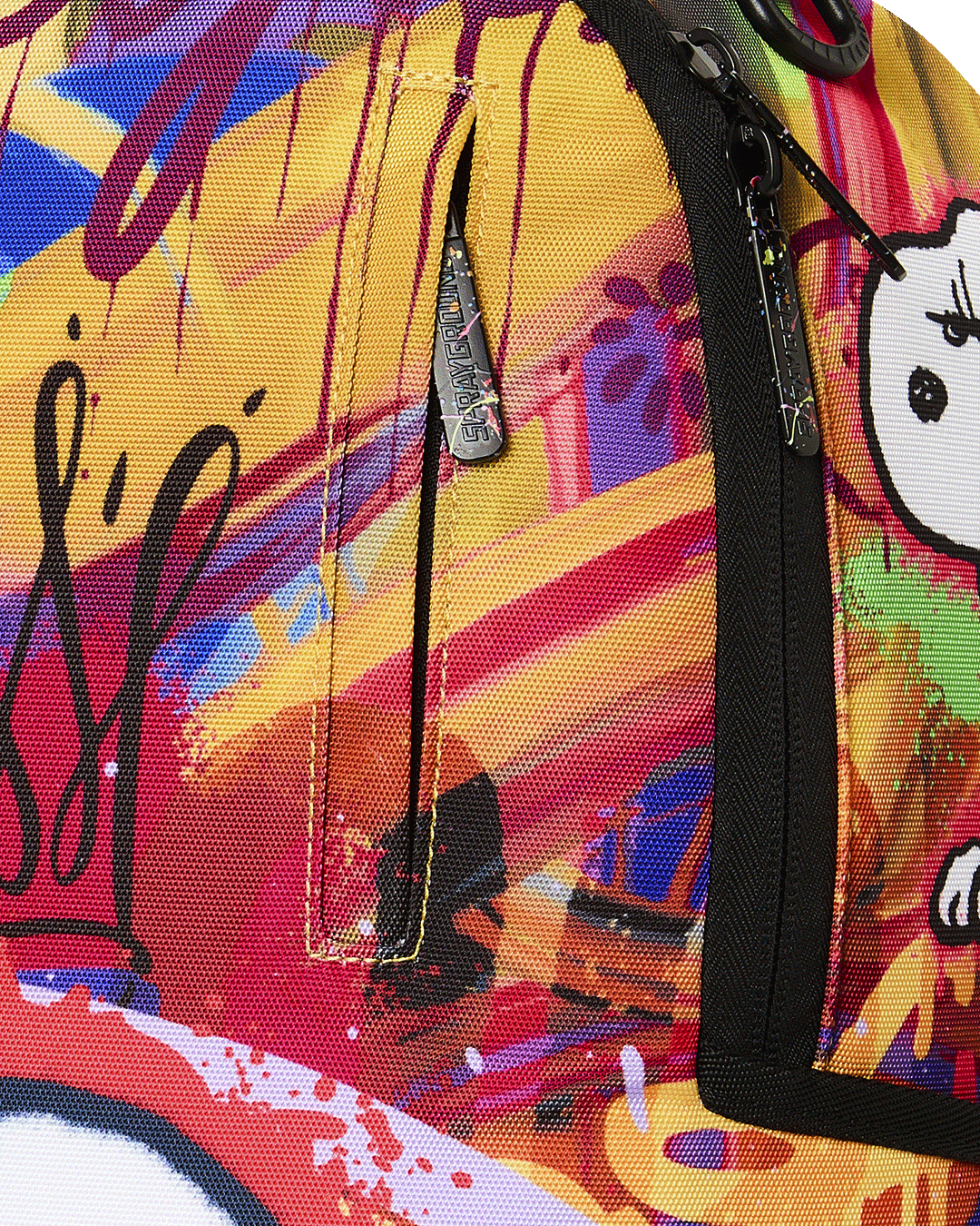 Close-up of zipper pull and side pocket on colorful Snoopy backpack with black trim