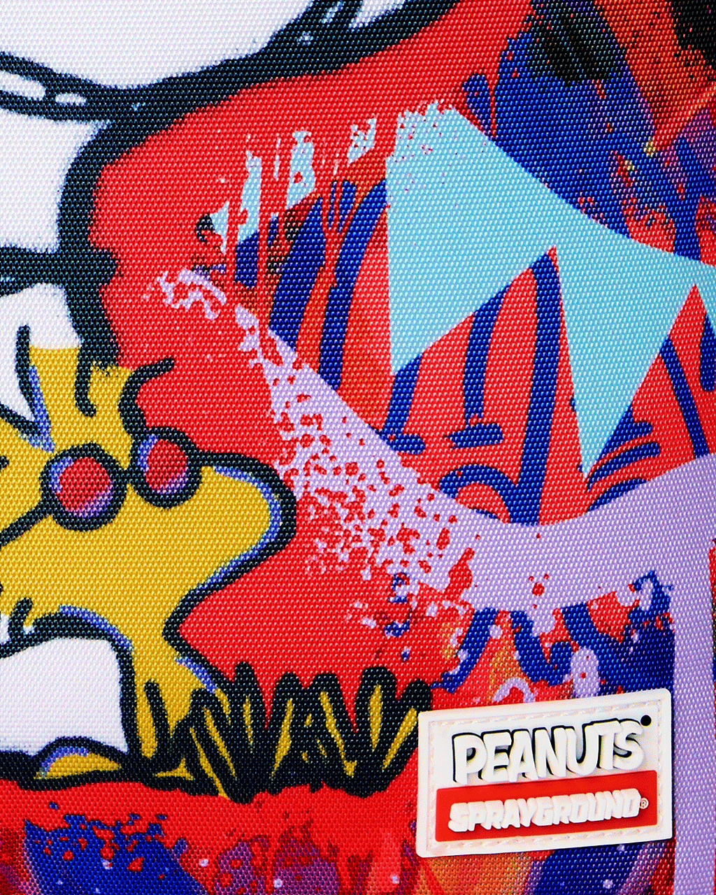 Close-up of Peanuts Snoopy backpack logo patch and colorful character artwork