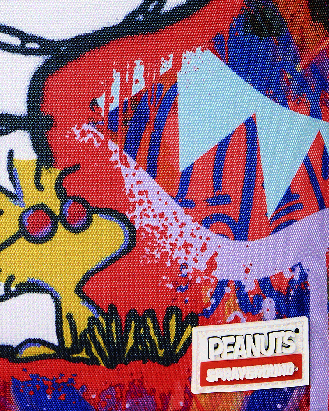 Close-up of Peanuts Snoopy backpack logo patch and colorful character artwork
