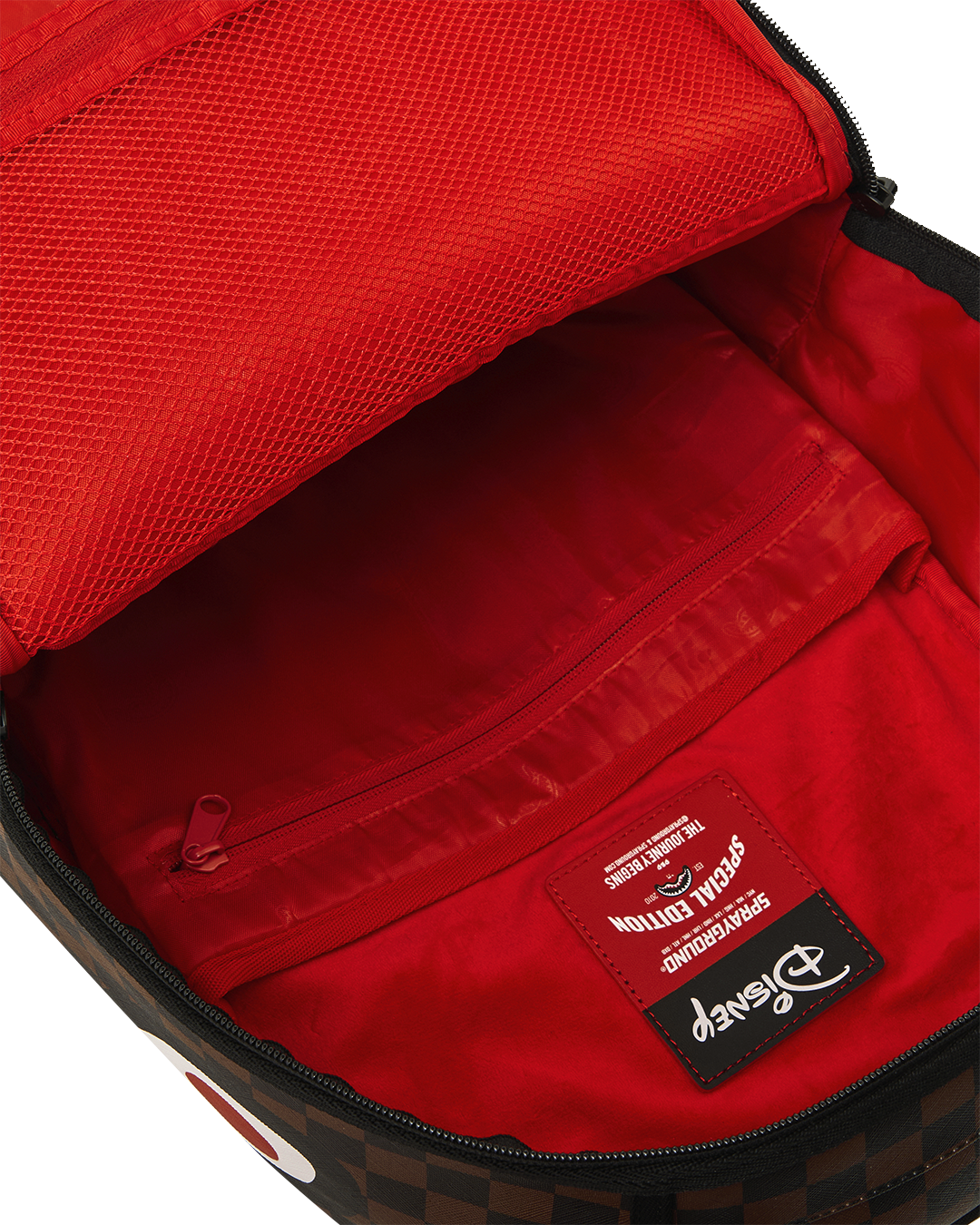 Backpack interior with red lining and zippered pocket, black trim