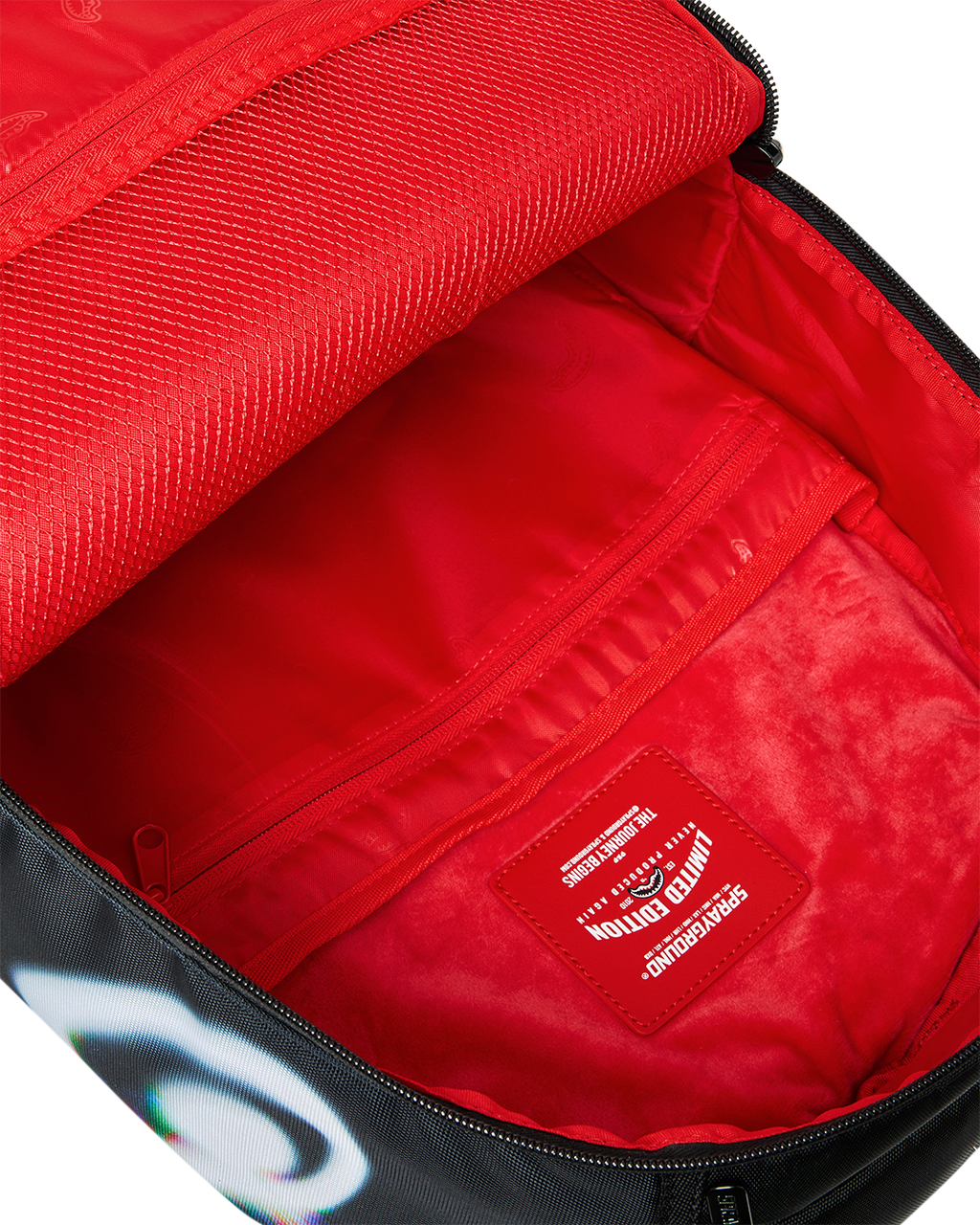 Sprayground Power Flex backpack open top showing red interior compartments