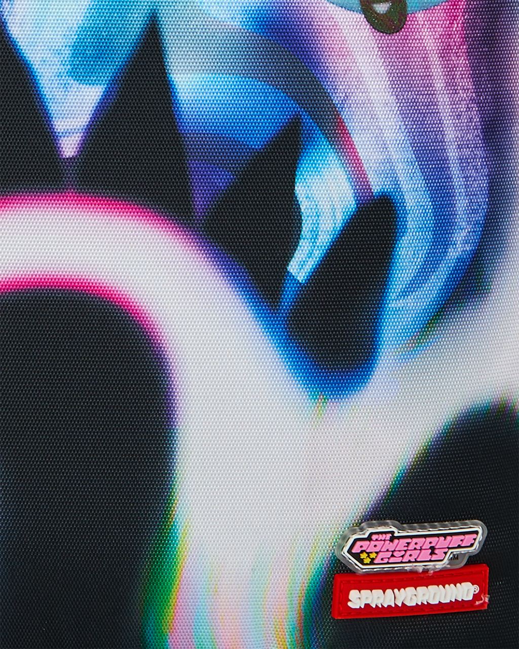 Sprayground Power Flex backpack close-up of Powerpuff logo patches on black fabric
