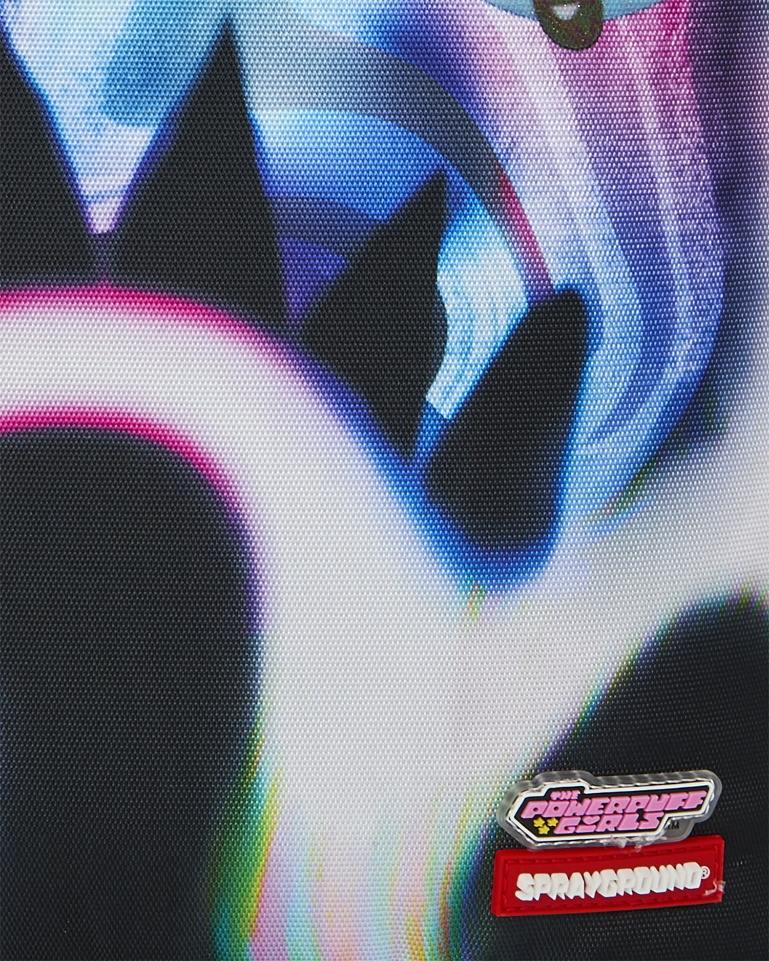 Sprayground Power Flex backpack close-up of Powerpuff logo patches on black fabric