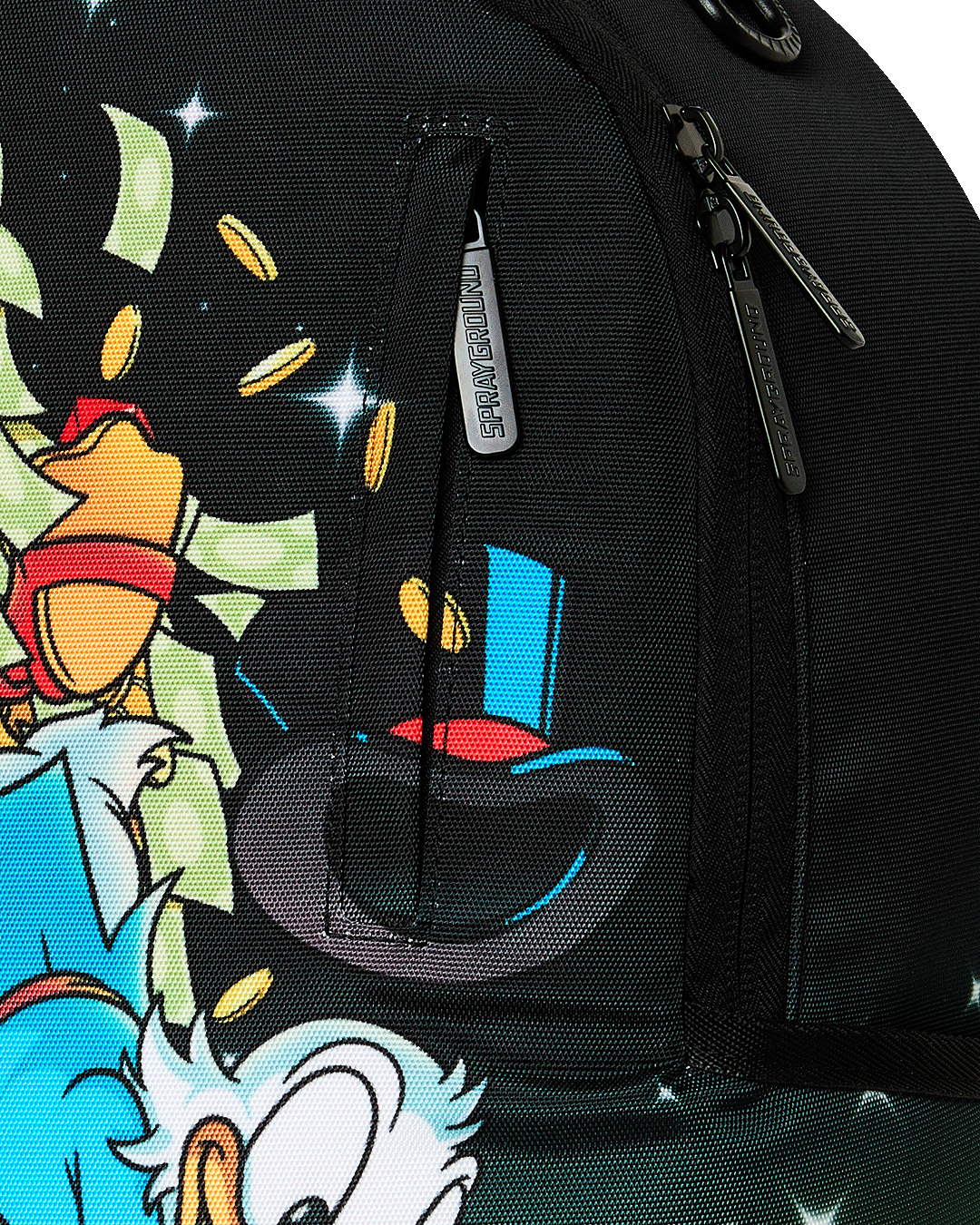 Sprayground Money Rider backpack bag close-up of black zipper pull and character fabric print