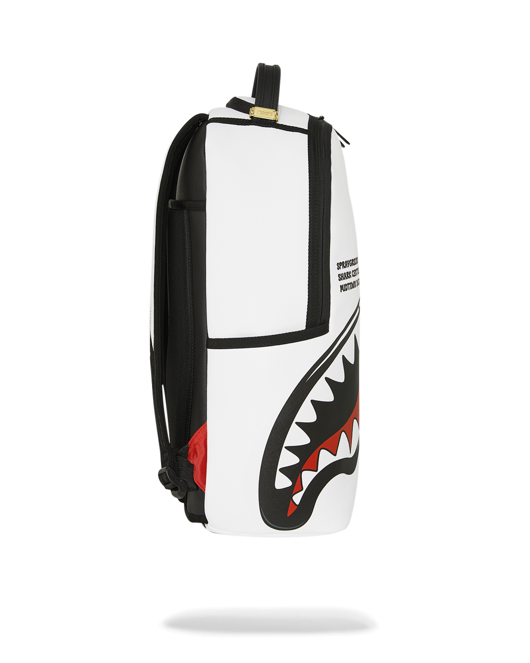 White and black backpack with shark artwork on side panel and black shoulder straps
