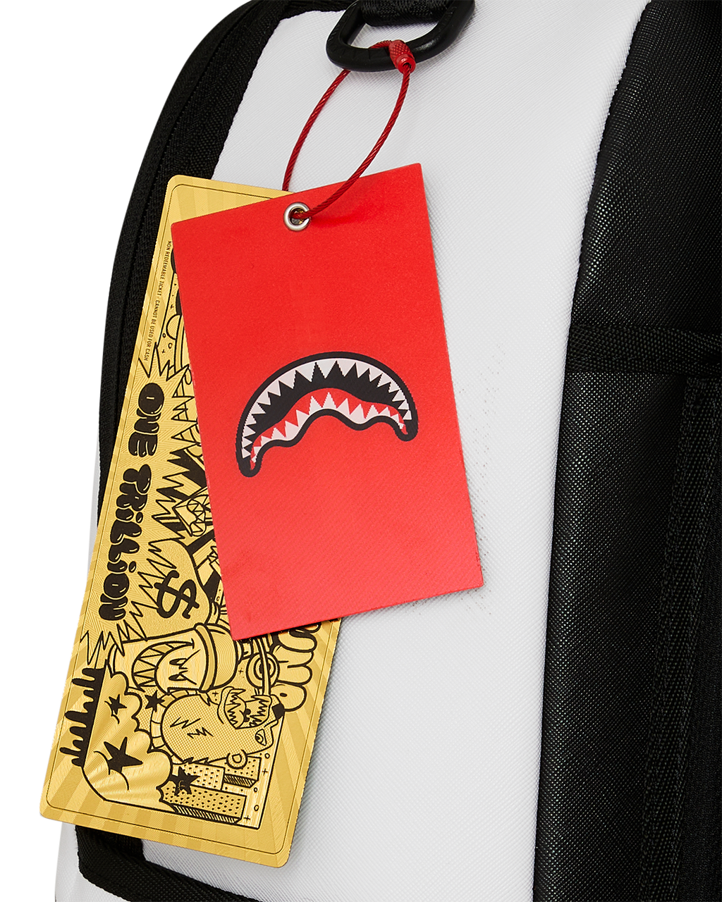 White backpack with hanging red shark tag and yellow brand tag on strap