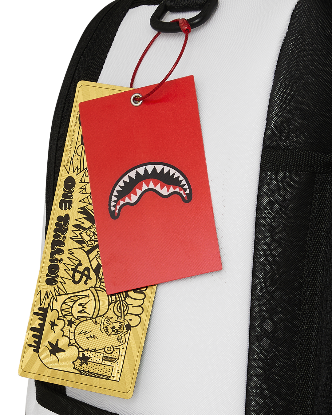 White backpack with hanging red shark tag and yellow brand tag on strap