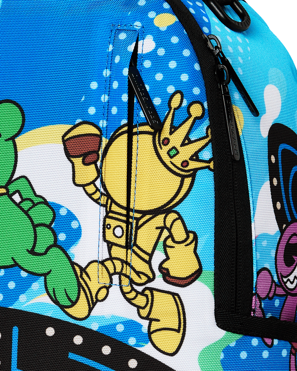 Close-up of blue backpack fabric with cartoon Pac-Man character print and zipper.