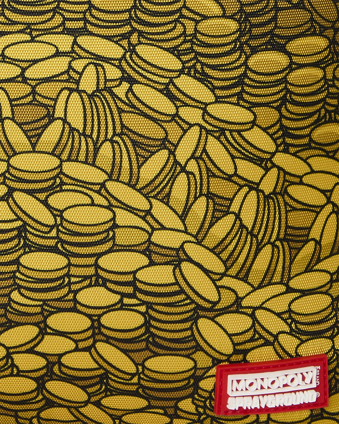 Close-up of yellow coin-pattern fabric with Monopoly Sprayground label