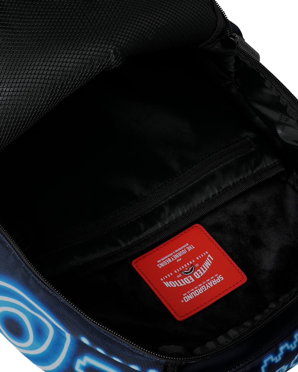 Backpack interior pocket with red brand label and black lining, zipper visible