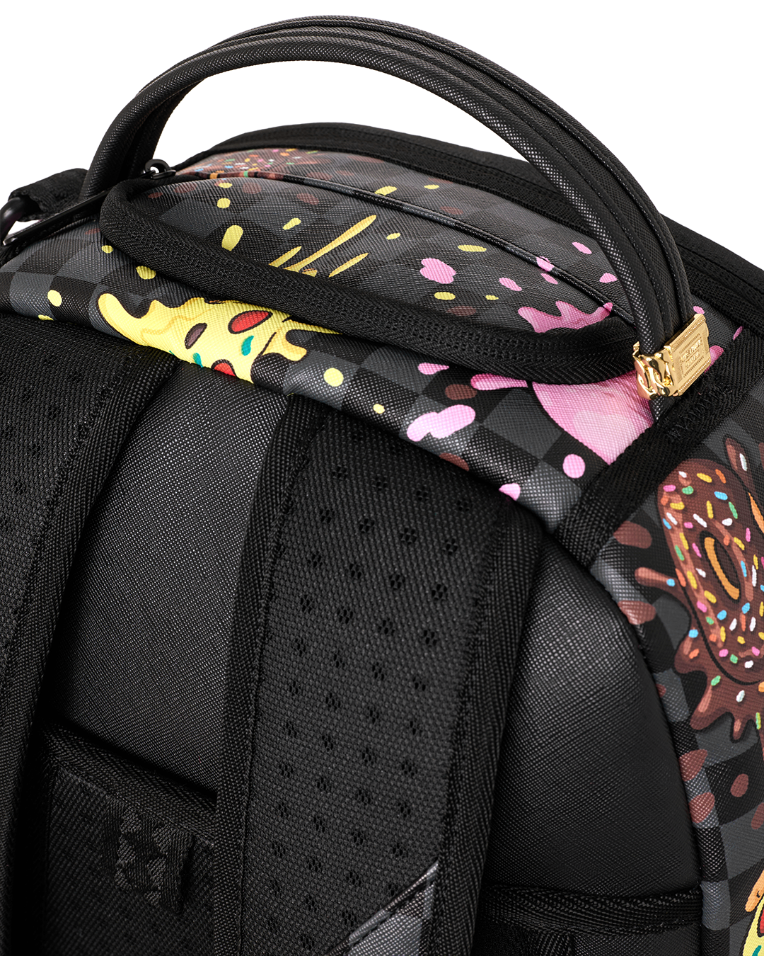 Black backpack close-up of patterned top handle strap and padded shoulder panel