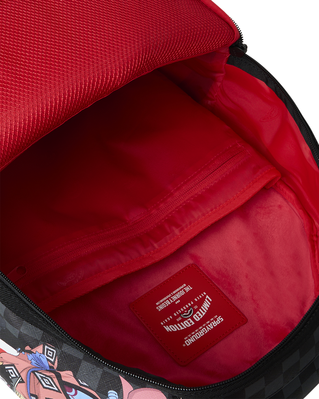 Sprayground backpack bag interior with red lining and brand patch on inner pocket