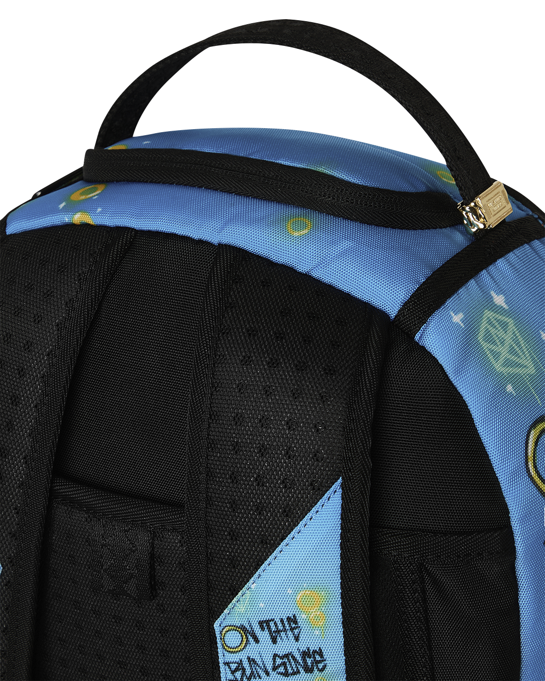 Top corner of blue backpack with black shoulder straps and woven loop handle