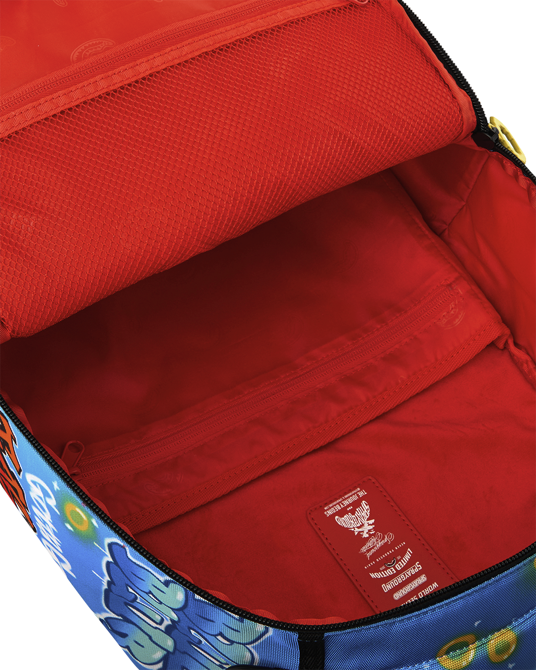 Open backpack interior with red lining and two compartments with zipper
