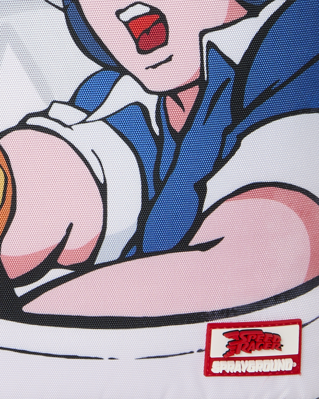 Close-up of cartoon character print and red-and-white “Sprayground” patch