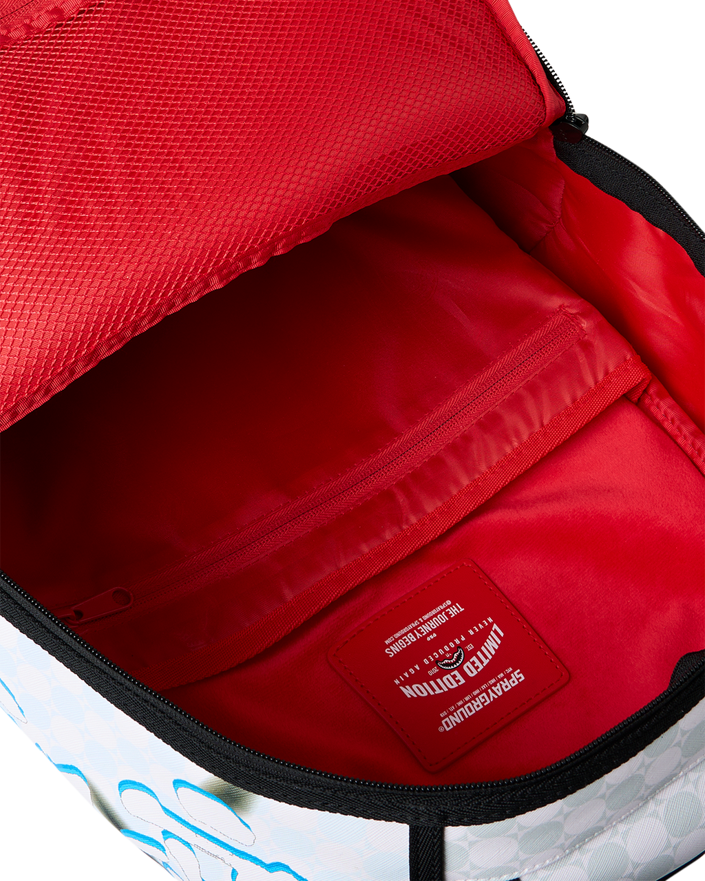 Open red-lined interior compartment with zipper on blue character backpack