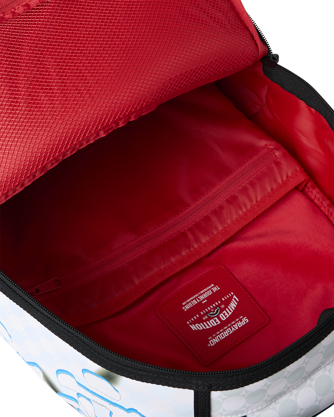 Open red-lined interior compartment with zipper on blue character backpack