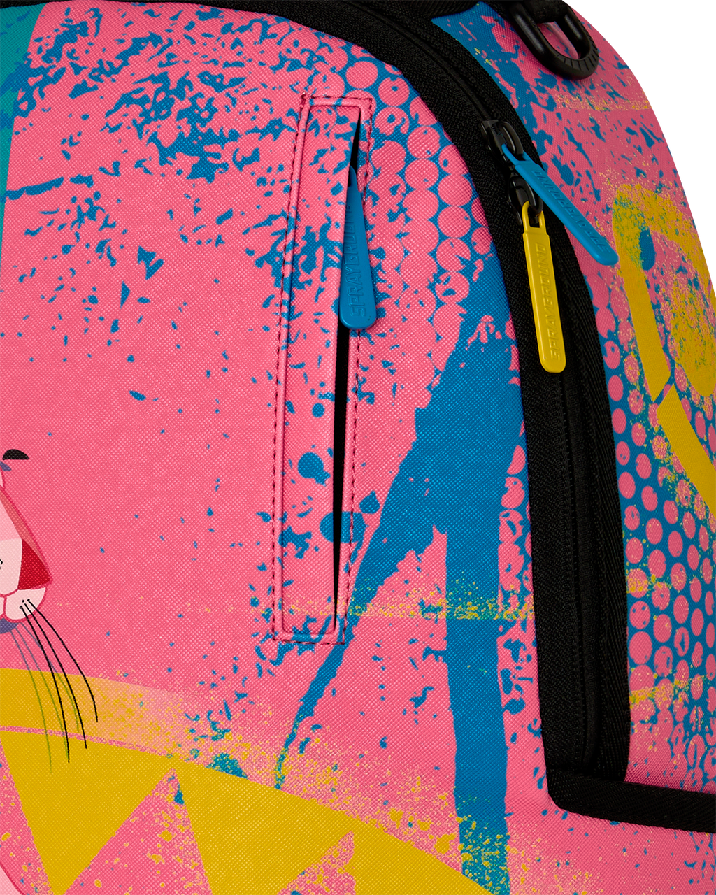 Close-up of art-print backpack fabric with blue zipper pull and pink textured pattern
