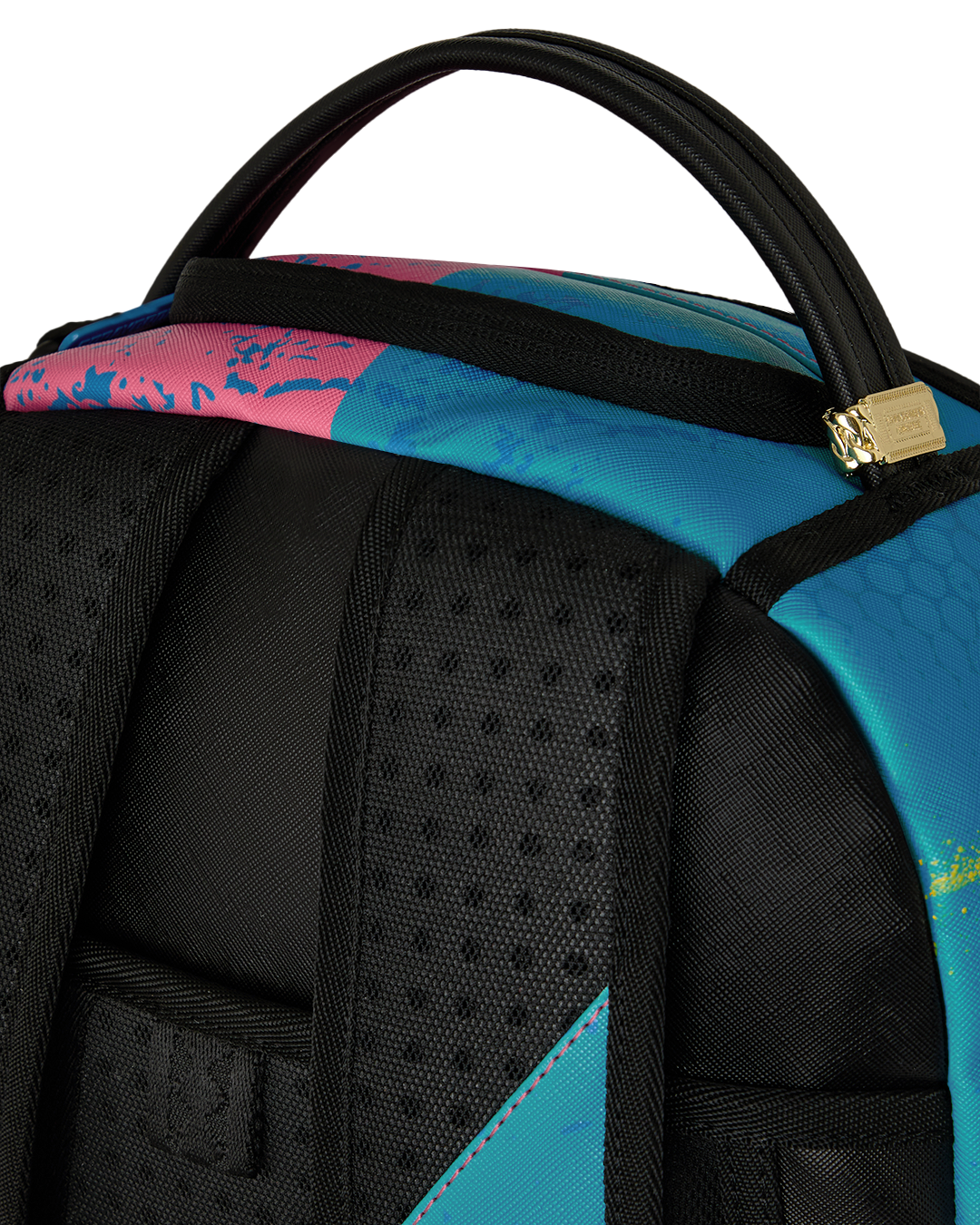 Close-up of top handle and black padded front section on colorful art-print backpack