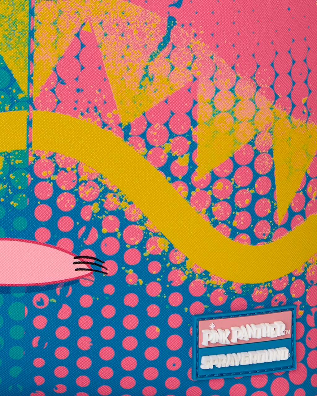 Close-up of colorful patch panel with pink dot pattern and rectangular brand label