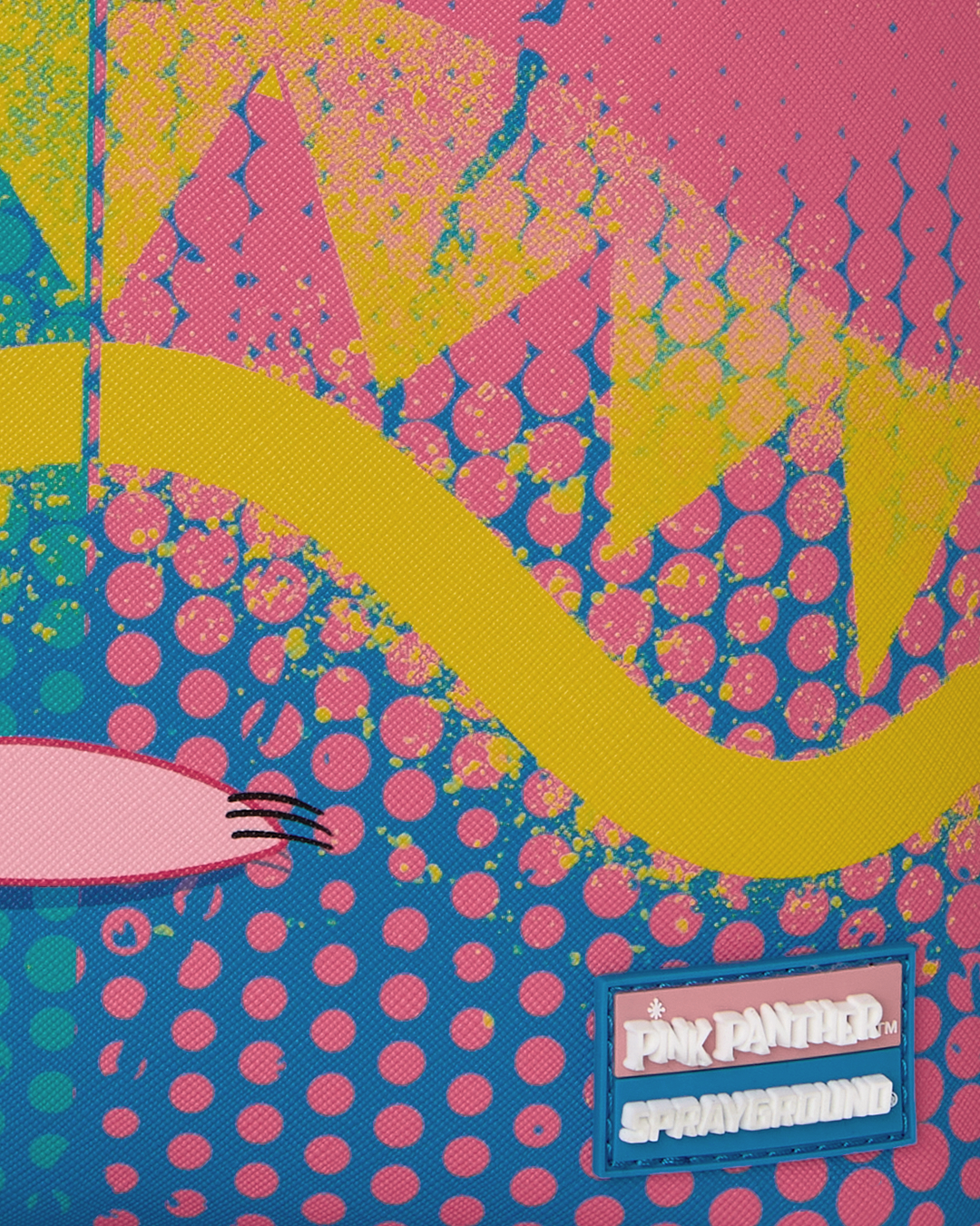 Close-up of colorful patch panel with pink dot pattern and rectangular brand label