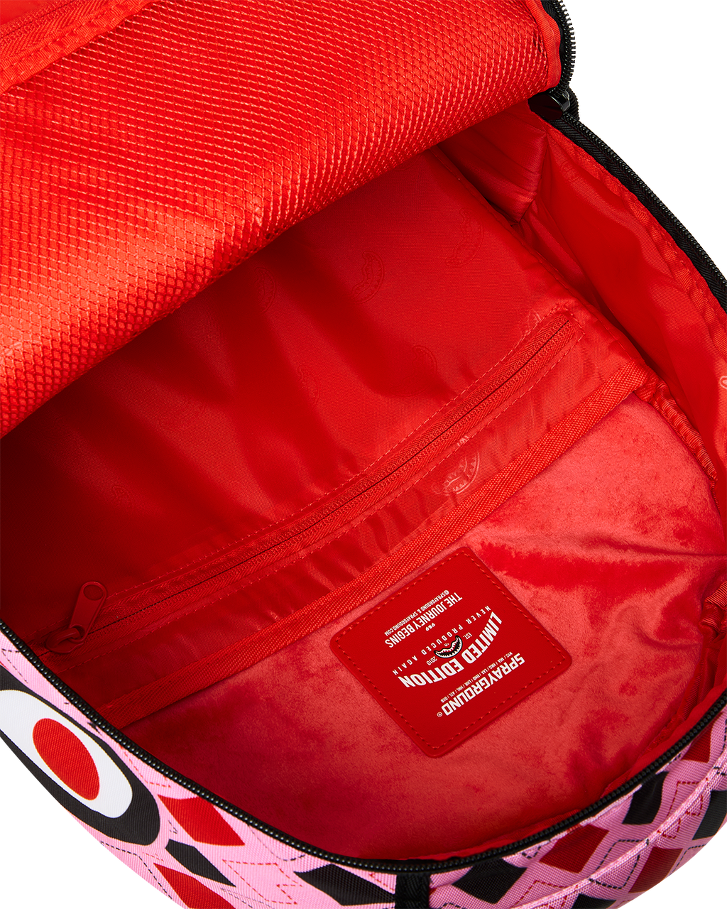 Harley Quinn backpack open interior with red lining and zipper pocket label.