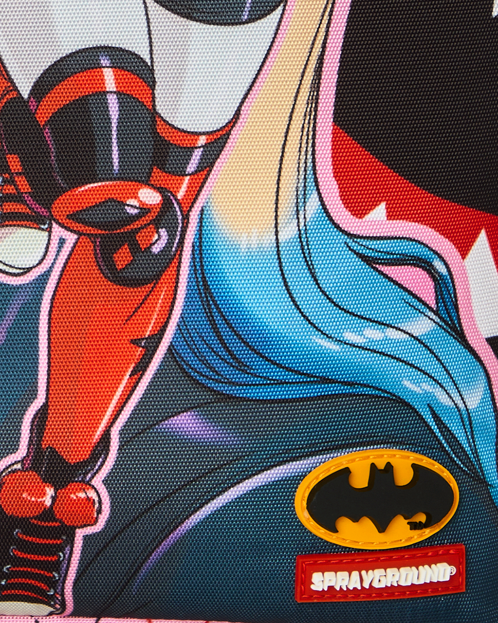Batman logo and Spryground patch on Harley Quinn backpack graphic background.