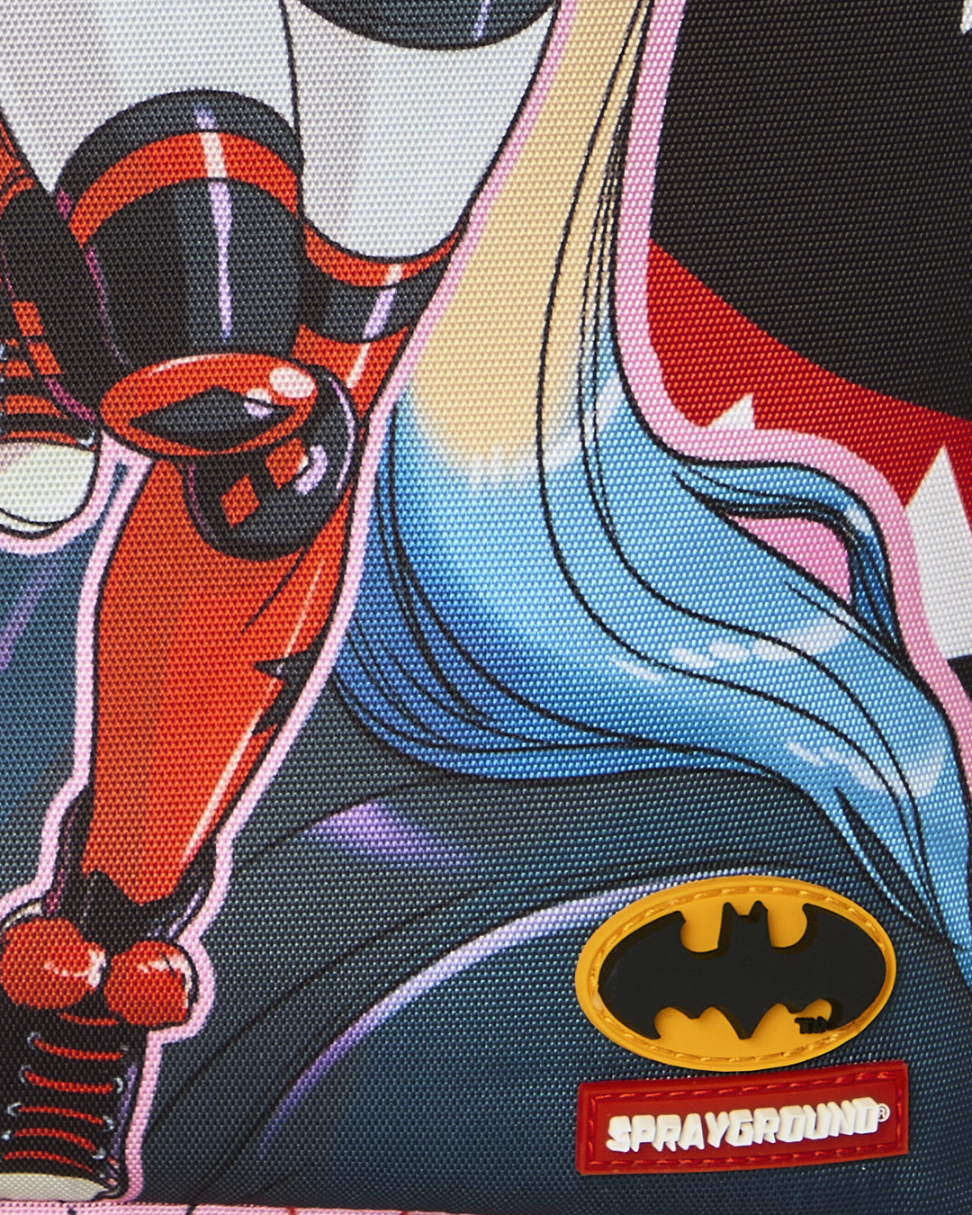 Batman logo and Spryground patch on Harley Quinn backpack graphic background.
