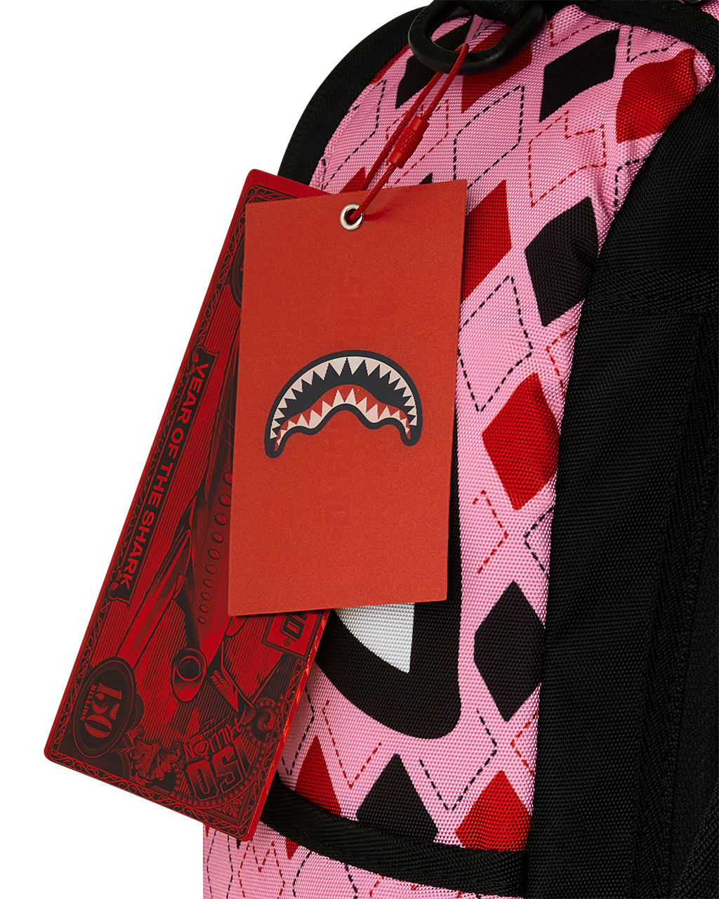 Harley Quinn backpack with red hang tag and pink-and-black patterned fabric near strap.