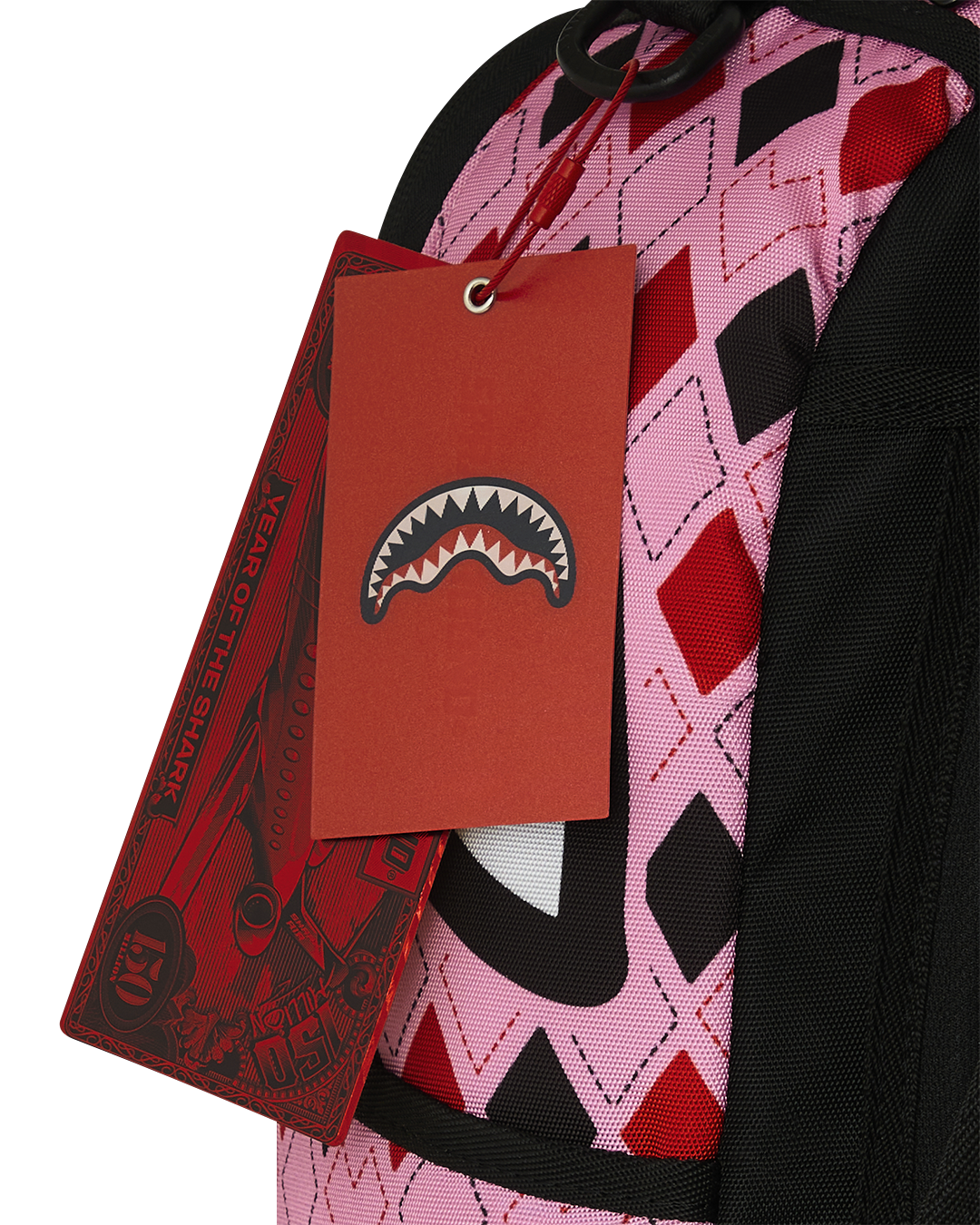 Harley Quinn backpack with red hang tag and pink-and-black patterned fabric near strap.