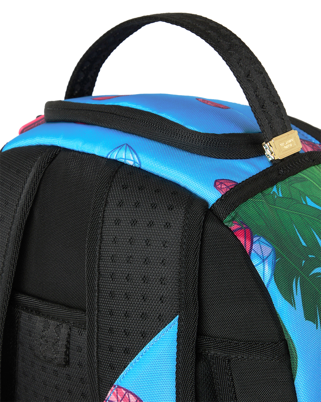 Close-up of blue backpack shoulder area with black padded straps and textured mesh