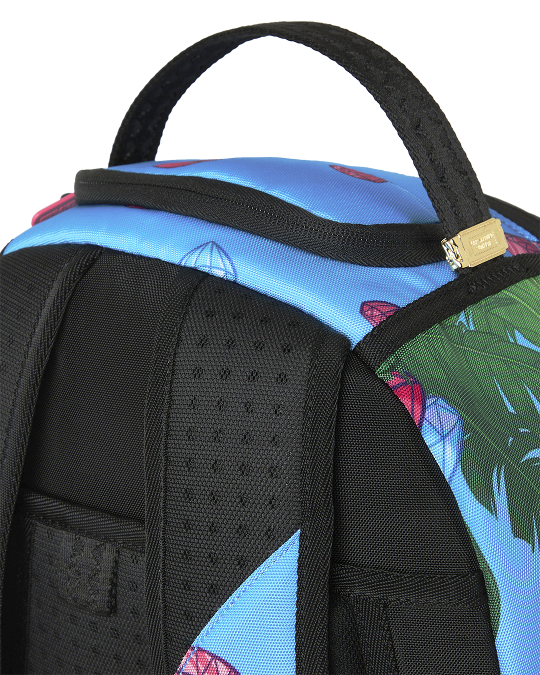 Close-up of blue backpack shoulder area with black padded straps and textured mesh