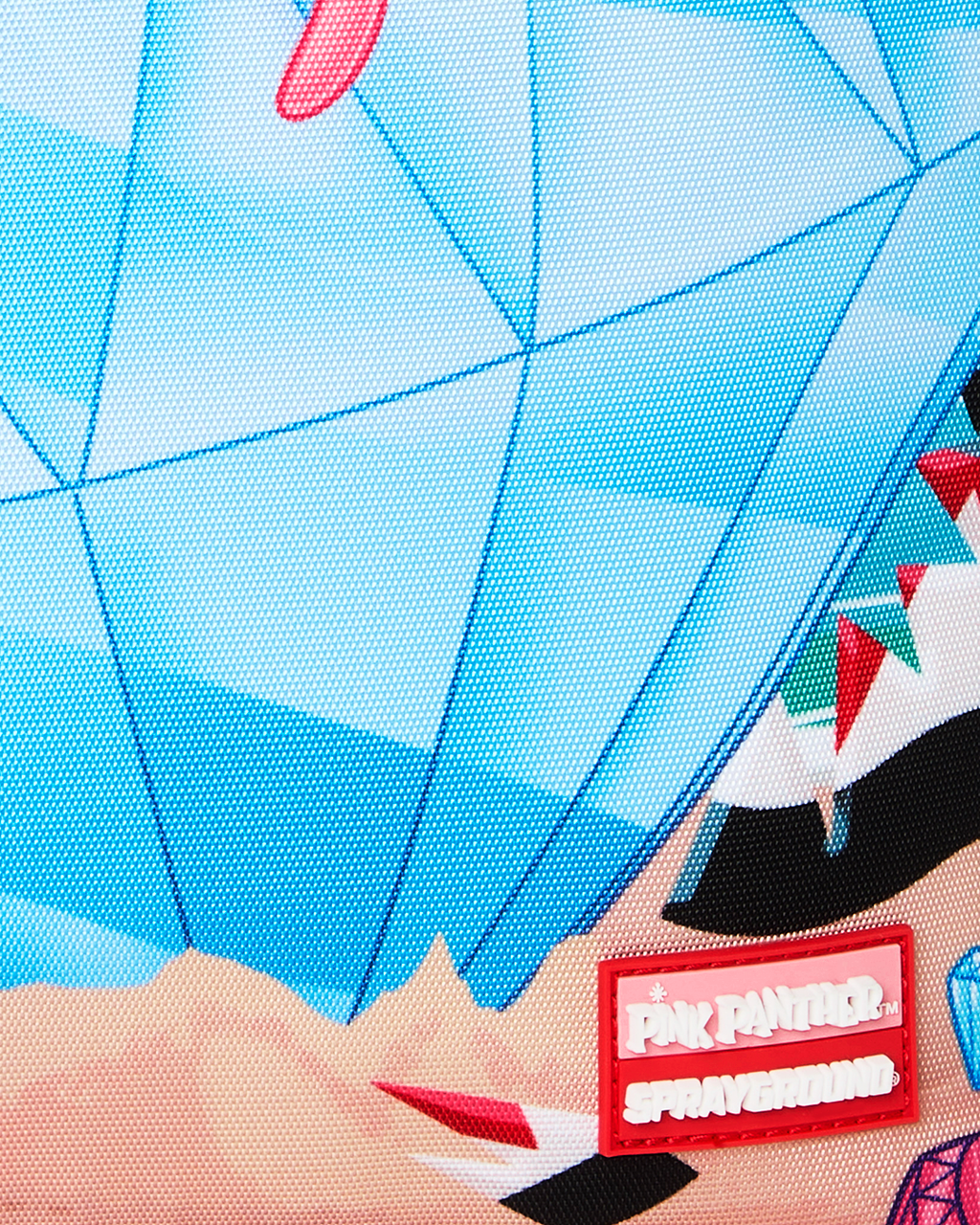 Close-up of blue backpack fabric with diamond pattern and red label patch