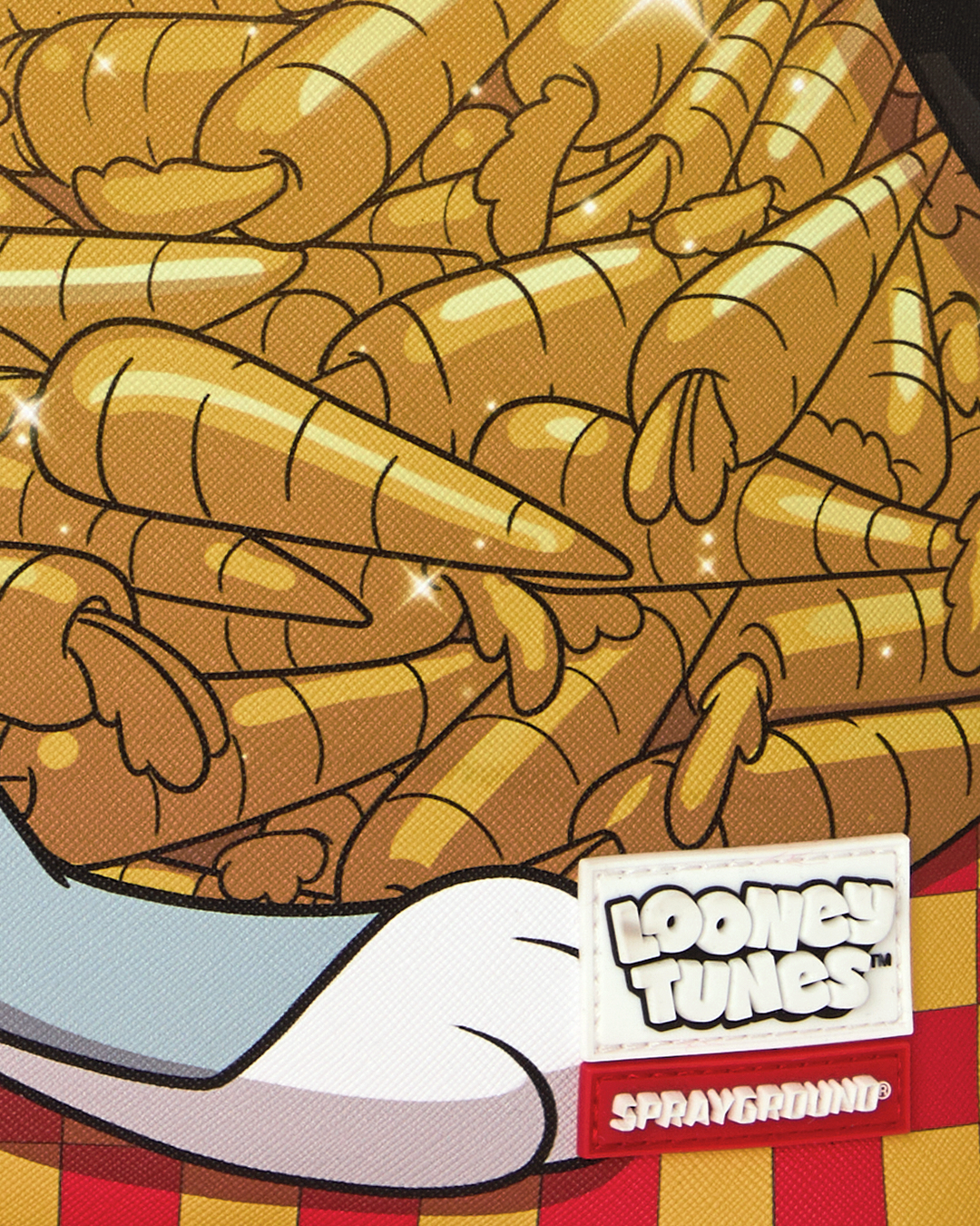 Close-up of carrot stack print fabric with Loonie Tunes and Sprayground labels