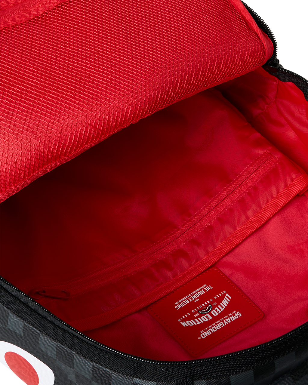 Open mini backpack showing red inner lining and interior slip pocket