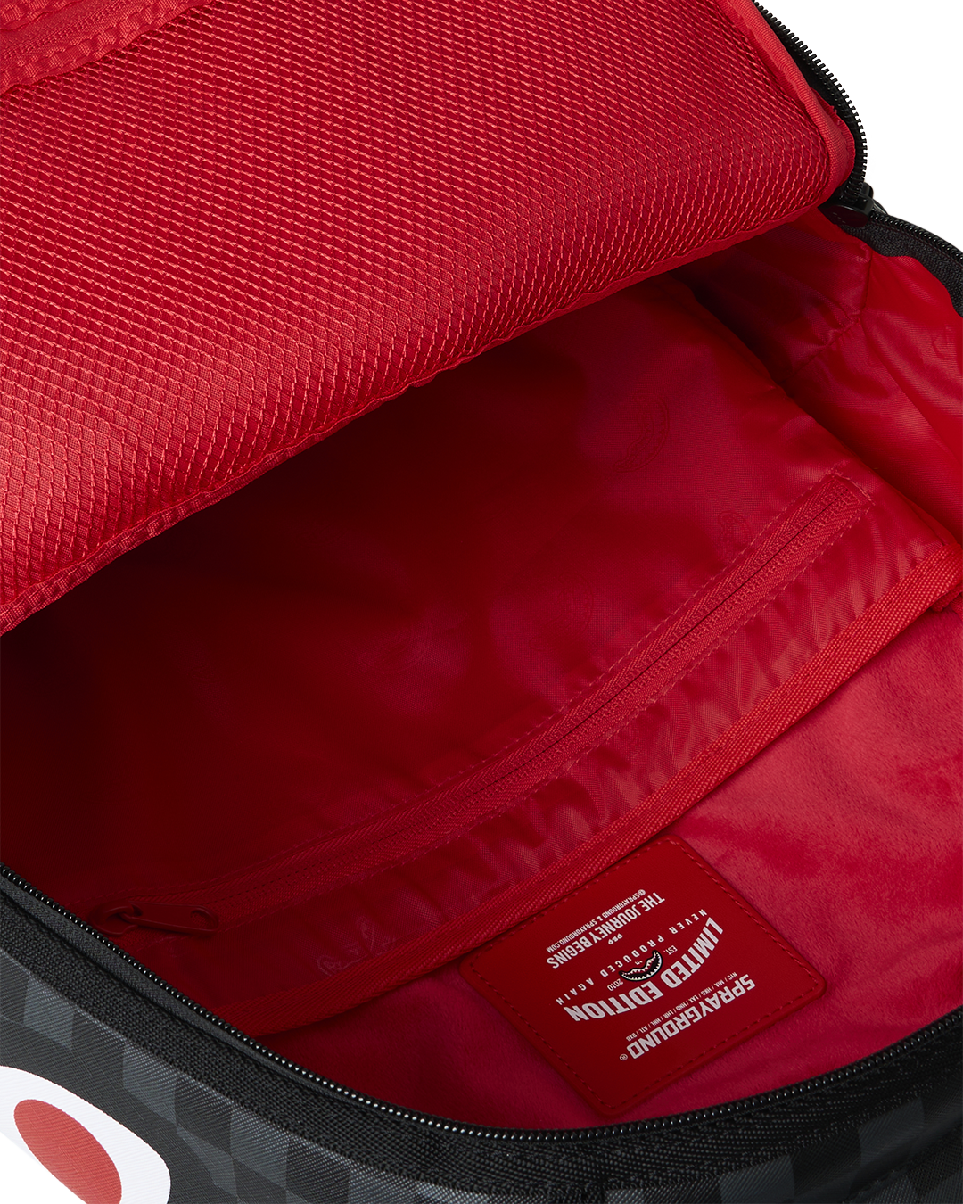 Open mini backpack showing red inner lining and interior slip pocket