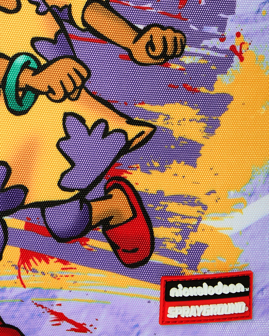 Kids backpack close-up with Nickelodeon and Sprayground-style brand patch