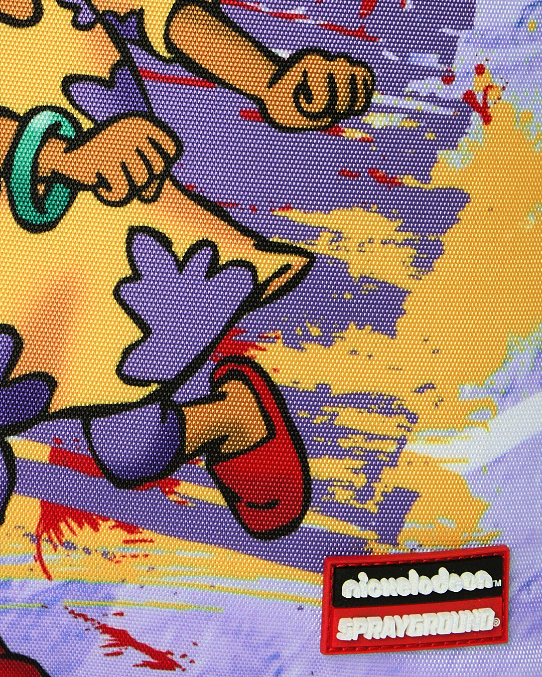Kids backpack close-up with Nickelodeon and Sprayground-style brand patch