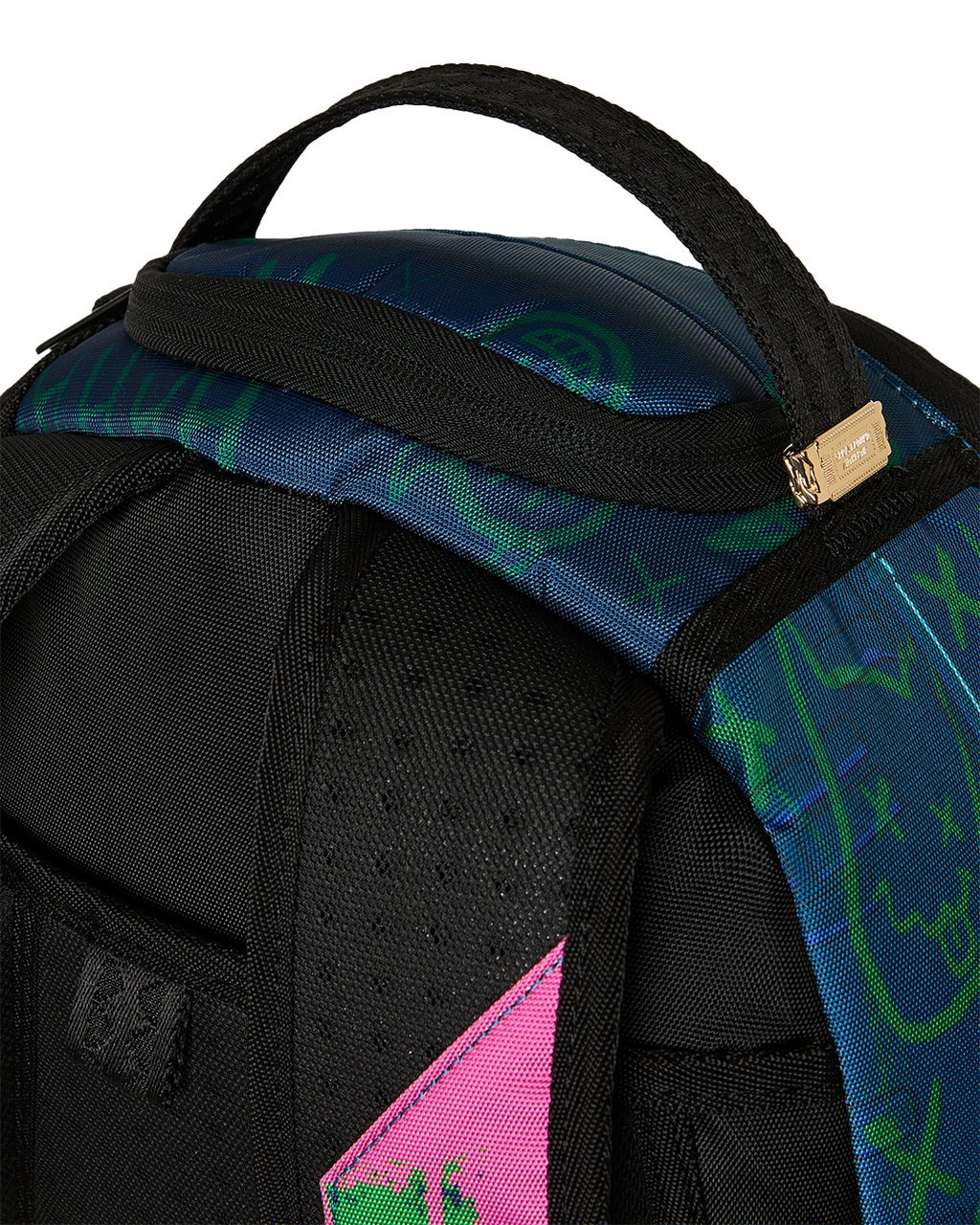 Mini backpack close-up of black strap, neon pattern panel, and stitched seams
