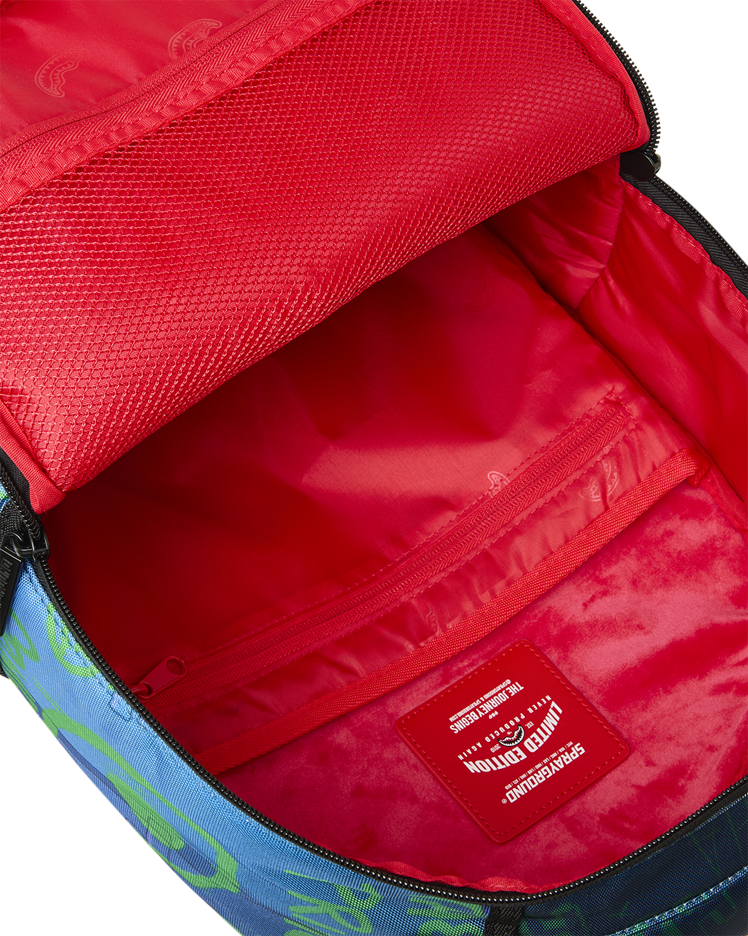 Inside view of mini backpack with red lining and zippered main compartment