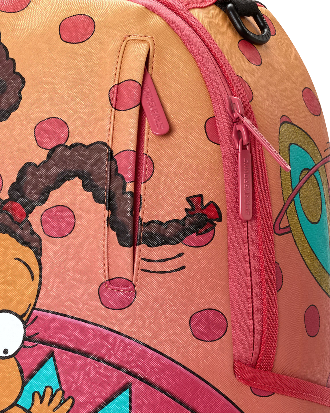 Sprayground mini backpack side close-up with pink zipper pull and character print.