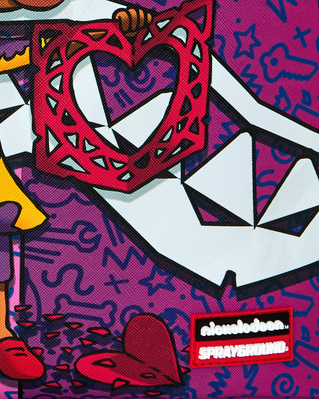 Close-up of purple backpack with Nickelodeon and Sprayground logo patch.